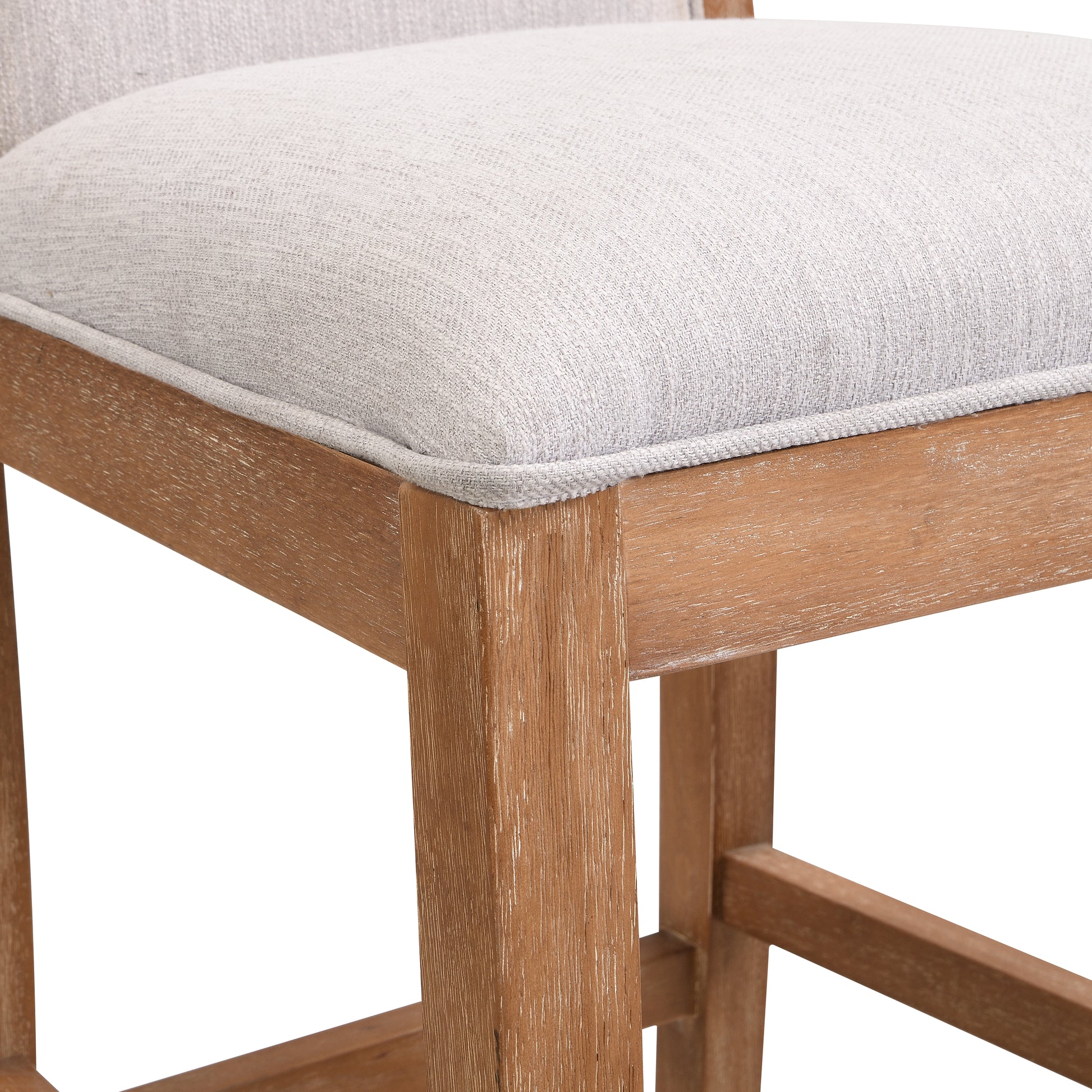 Closeup of light grey textured fabric seat on a rustic wooden bar stool