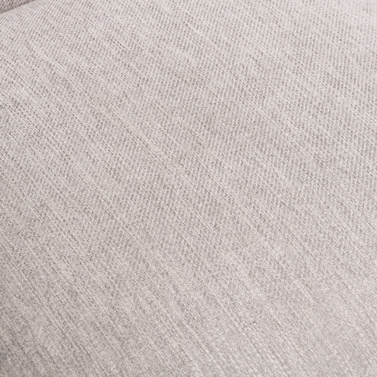Closeup of light gray linen fabric with a subtle herringbone weave pattern