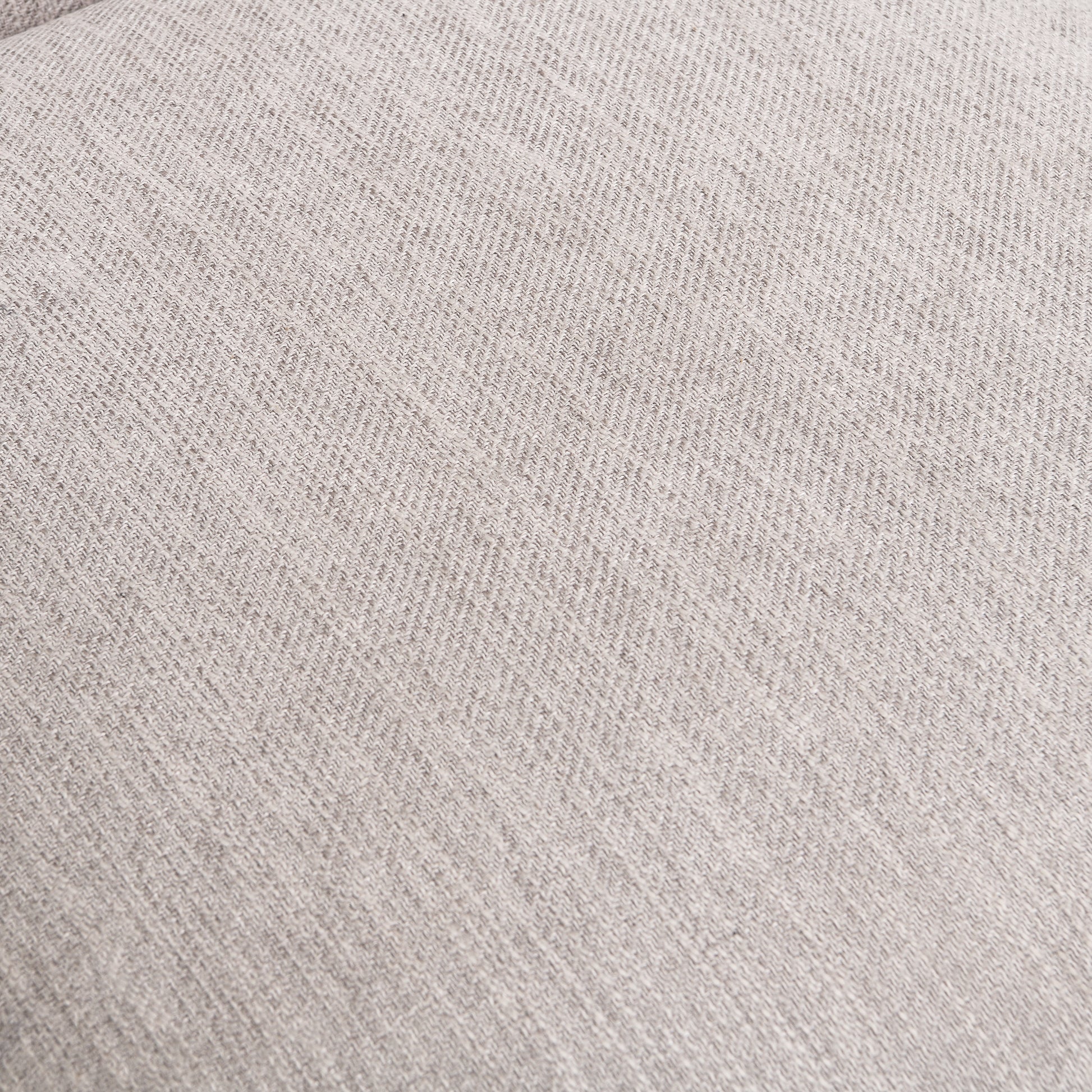 Closeup of light gray linen fabric with a subtle herringbone weave pattern