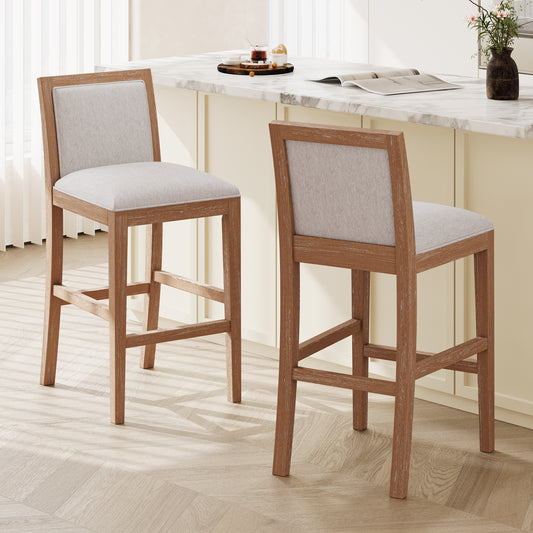 Two light gray upholstered bar stools with weathered oak frames perfect for a kitchen island
