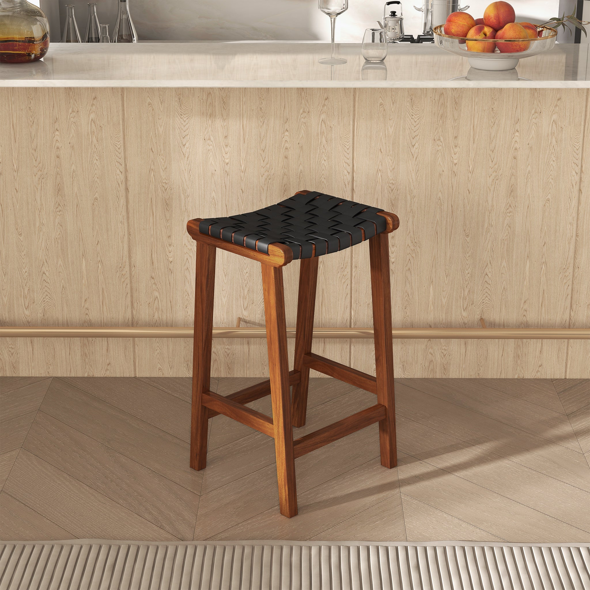 Elegant saddle stool with woven black leather seat and solid wood frame perfect for a modern kitchen counter