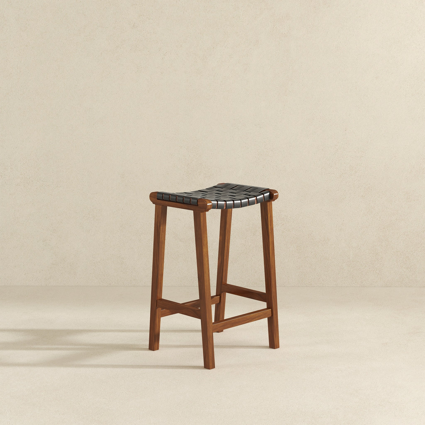 Wooden counter stool with woven black leather seat and warm walnut finish