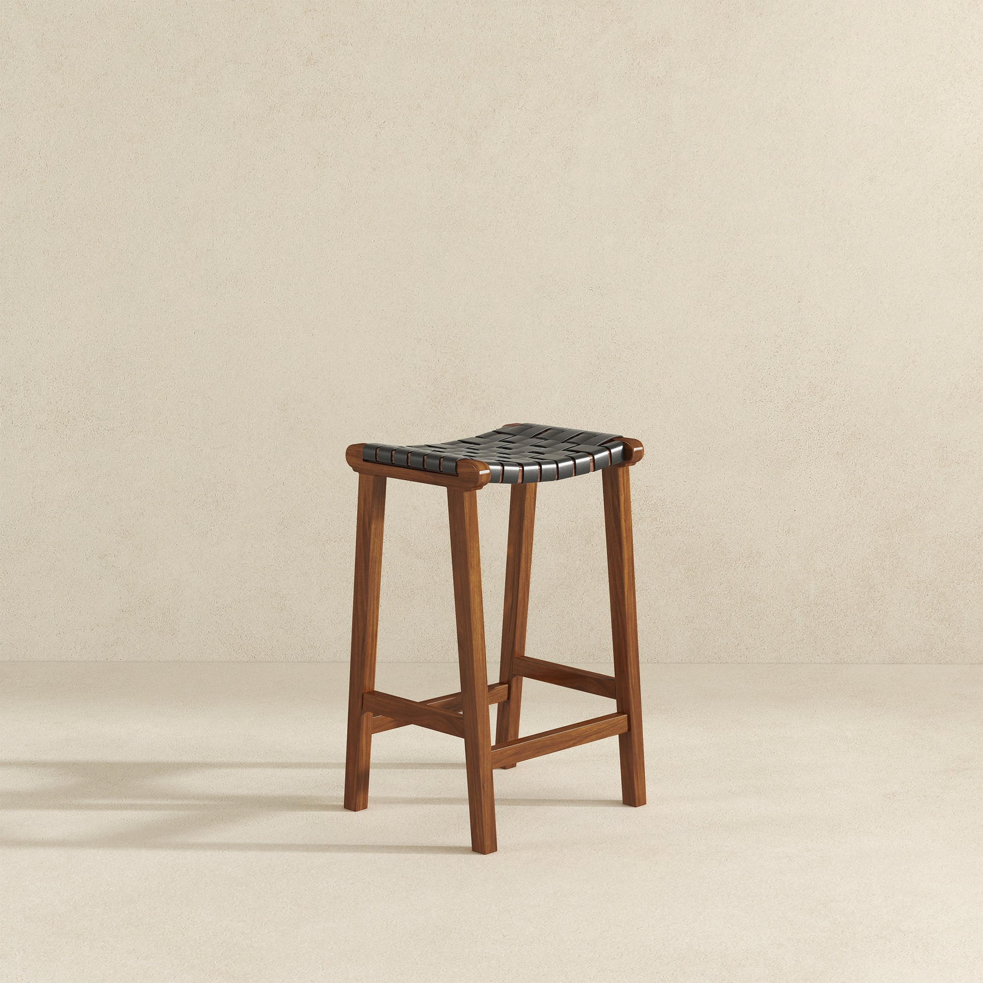 Wooden counter stool with woven black leather seat and warm walnut finish