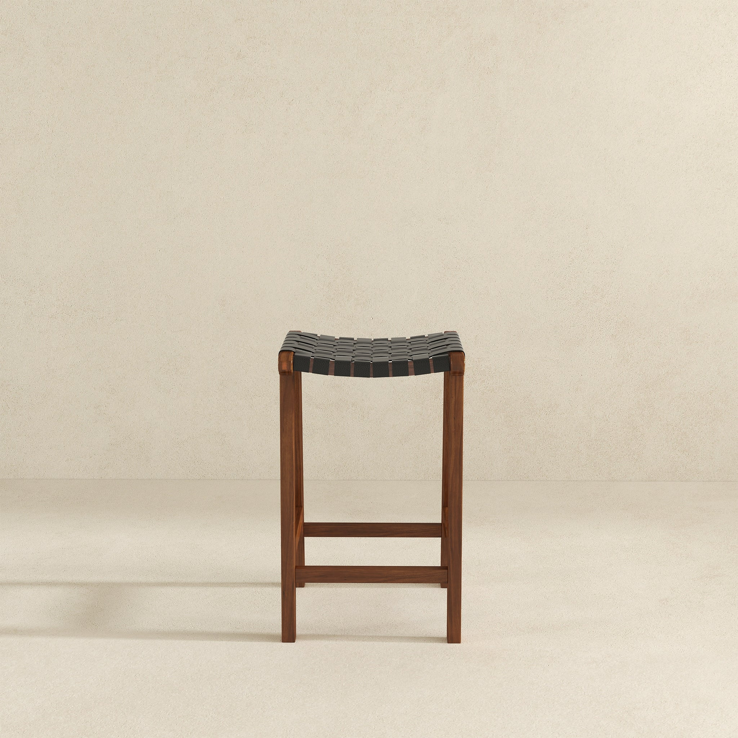 Dark wood and black leather woven counter stool with a minimalist design