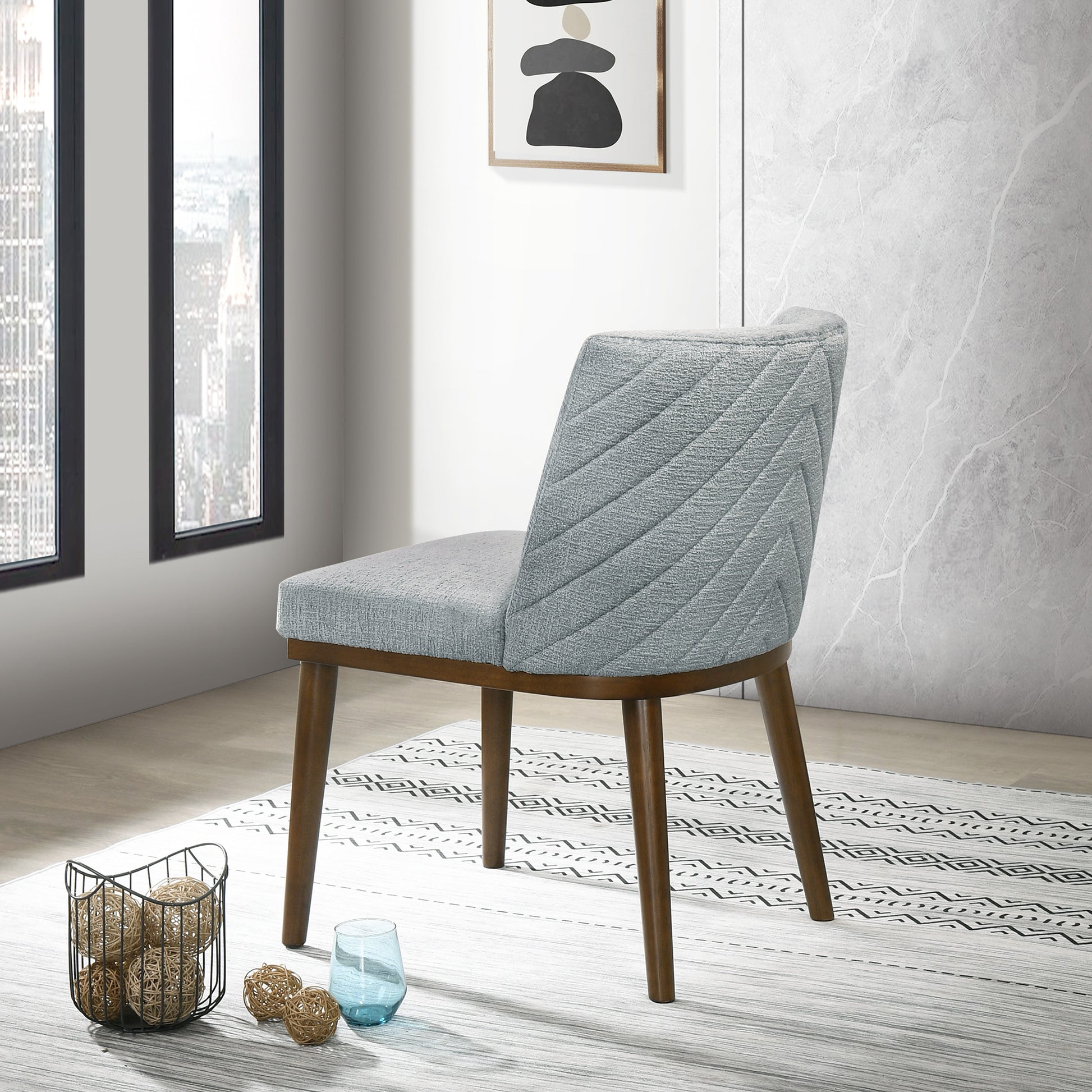 Midcentury modern grey upholstered dining chair with quilted chevron pattern