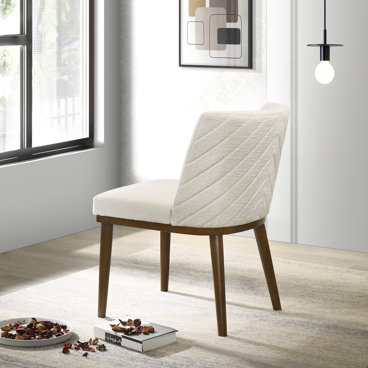 Cream upholstered dining chair with quilted back and dark wood legs