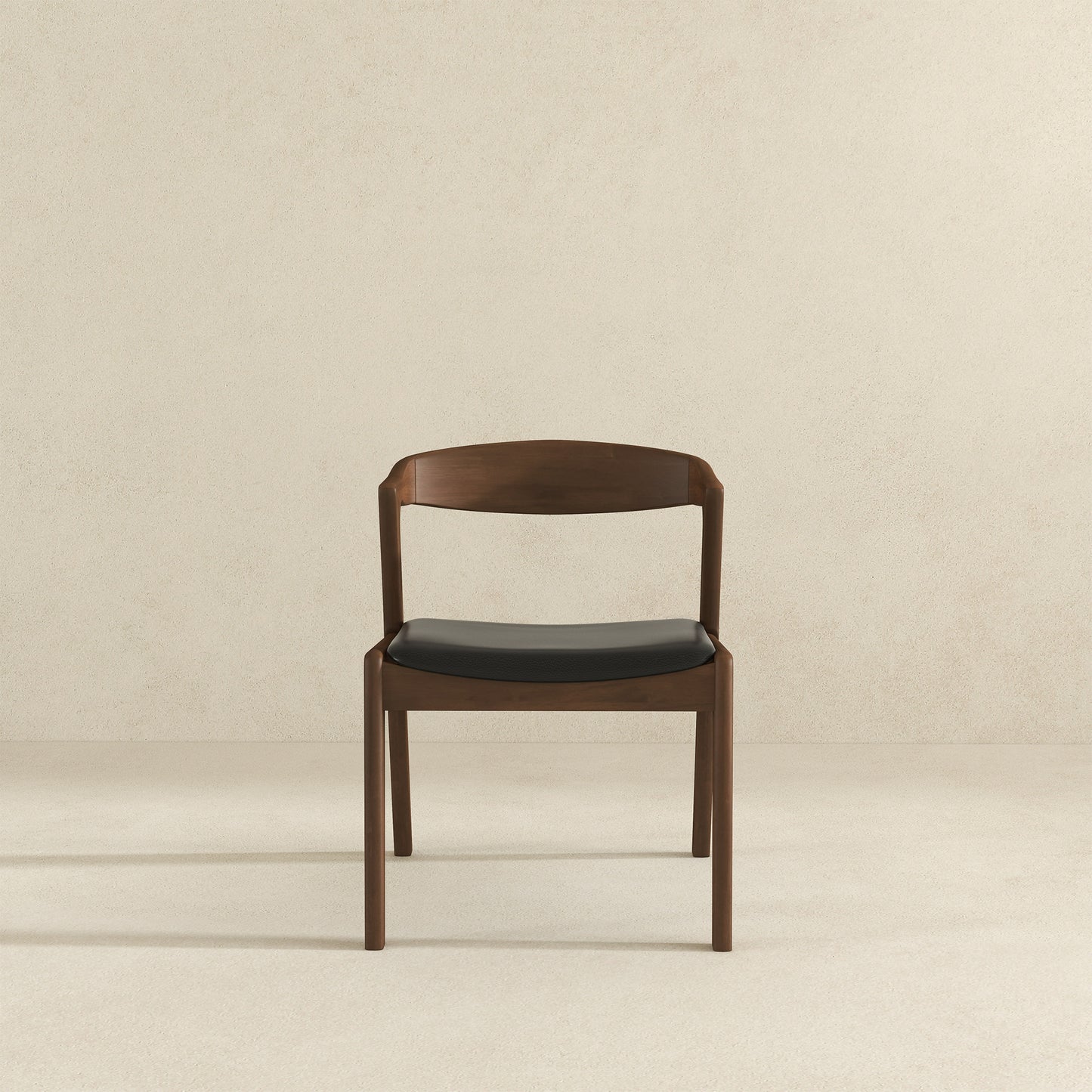 Modern walnut dining chair with a black upholstered seat and curved back