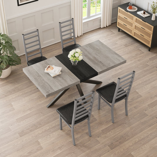 Rustic grey wood dining table with metal legs and black padded chairs seats