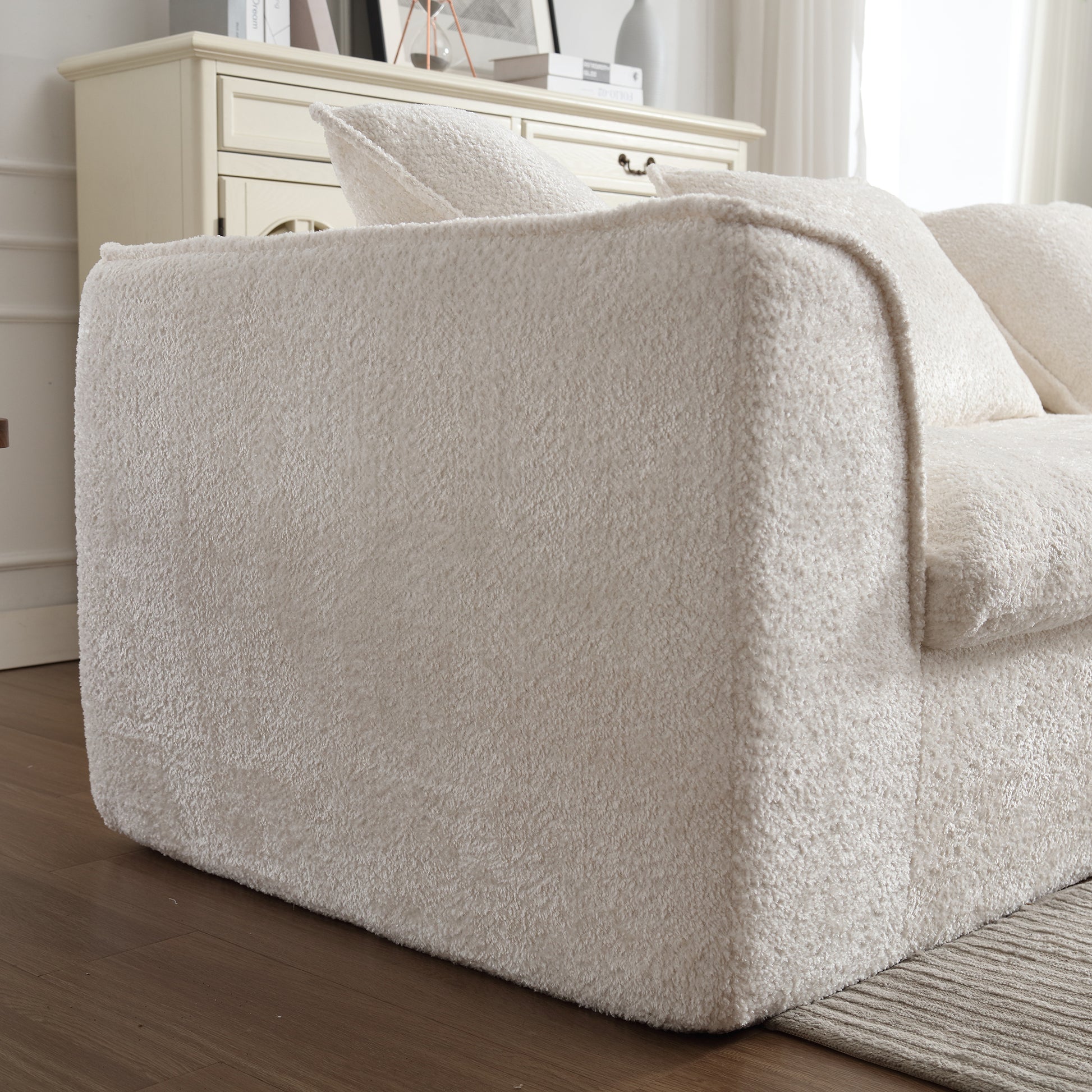 Cream boucle fabric sofa armrest with plush cushion cozy living room accent