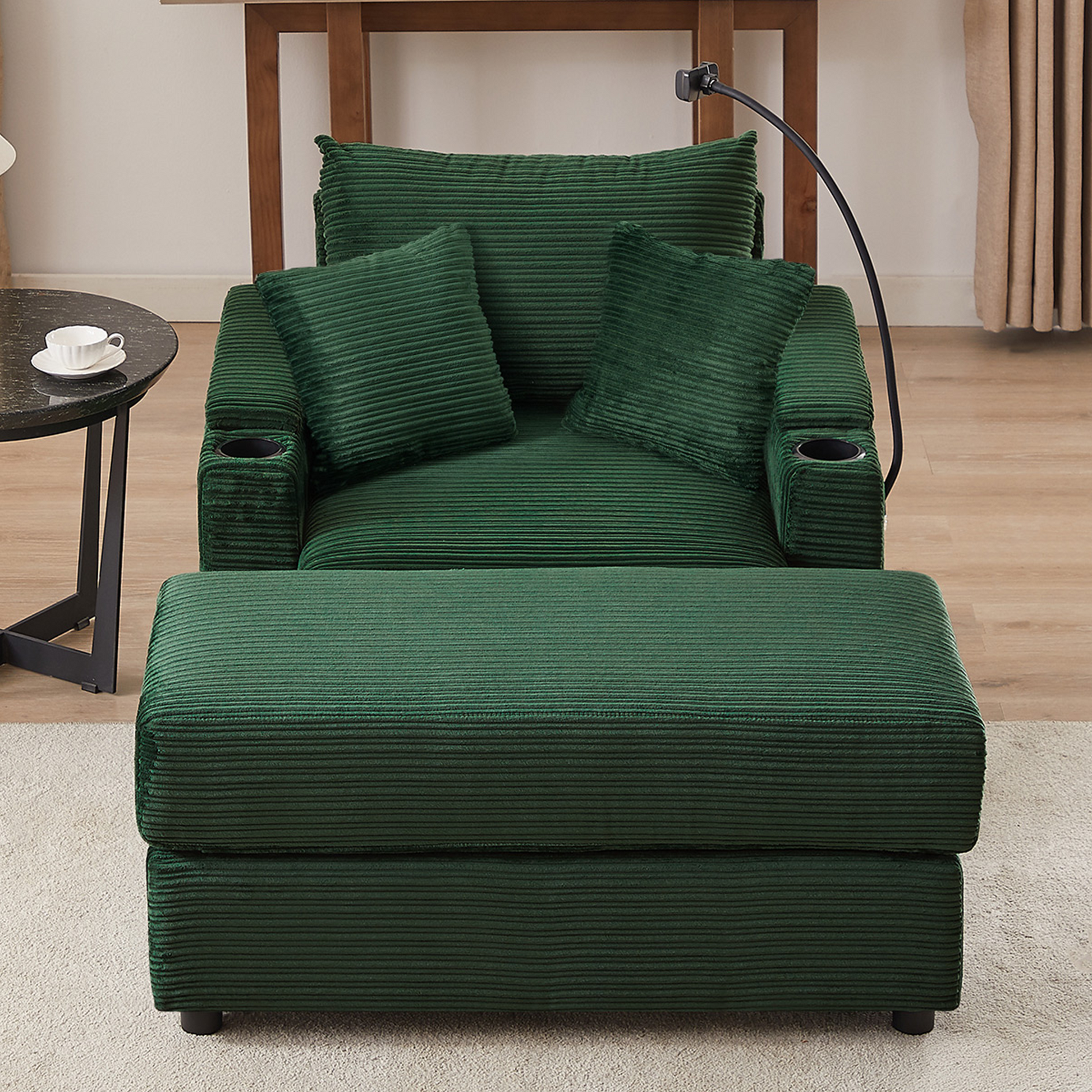Deep green corduroy recliner with matching ottoman and two accent pillows featuring builtin cup holders