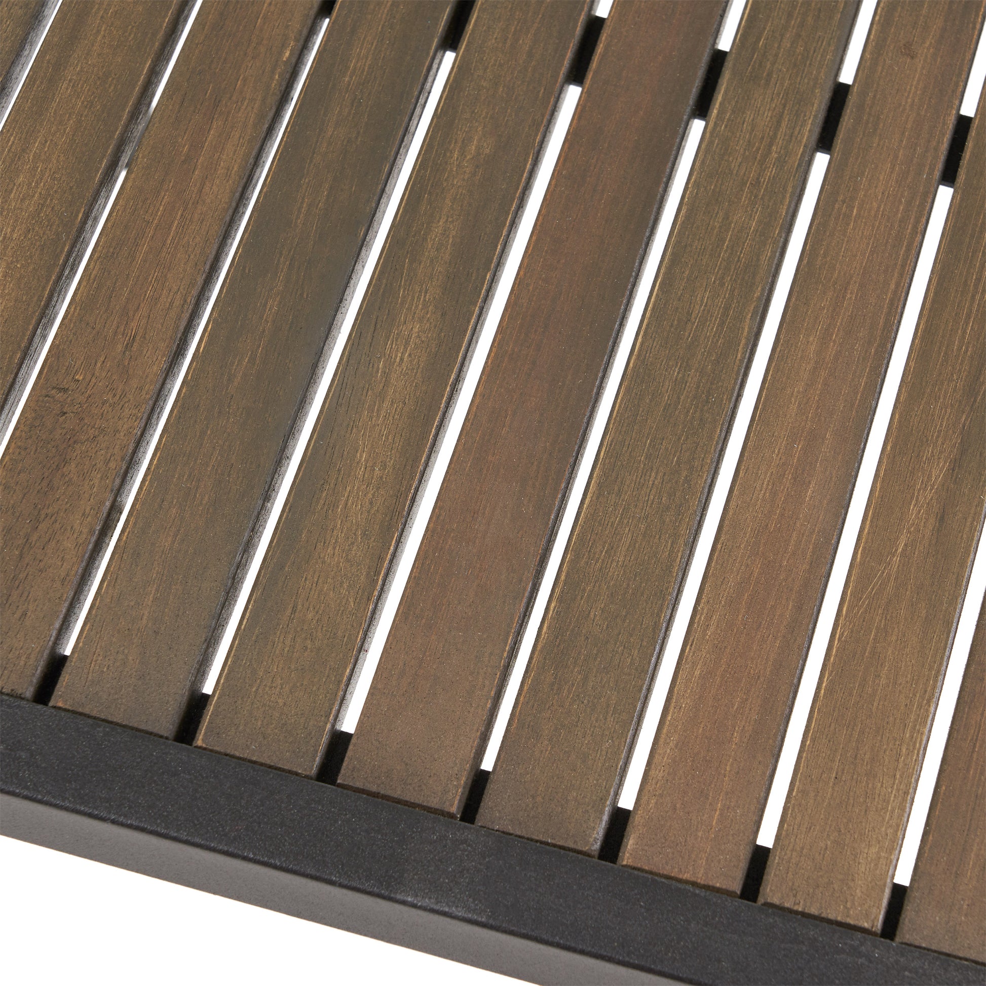 Closeup of brown slatted wood tabletop on a black metal frame