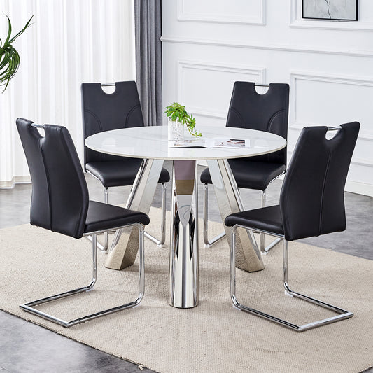 White round dining table with four black leather cantilever chairs