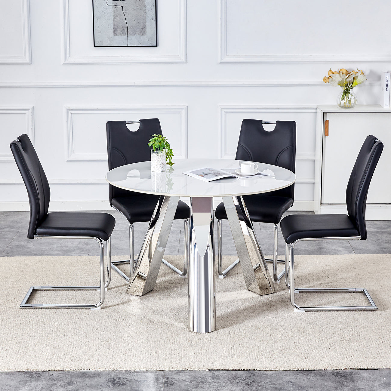 Modern white round dining table with four black leather chairs