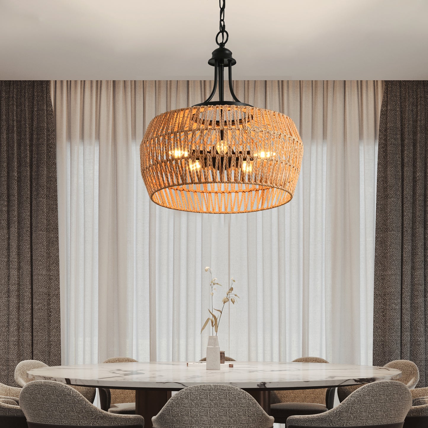 Woven rattan pendant light with black metal accents illuminating a dining room setting
