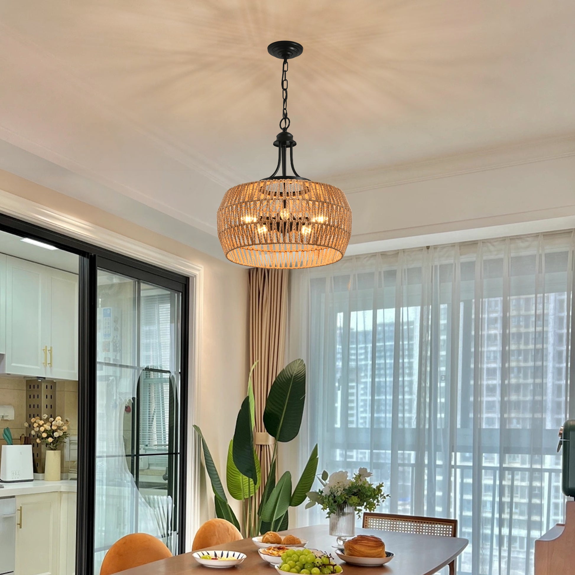 Woven natural fiber pendant light with a black metal frame hangs above a dining table