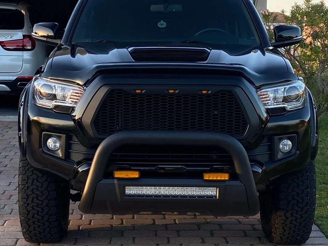 Black Toyota Tacoma offroad bumper with LED light bar and bull bar
