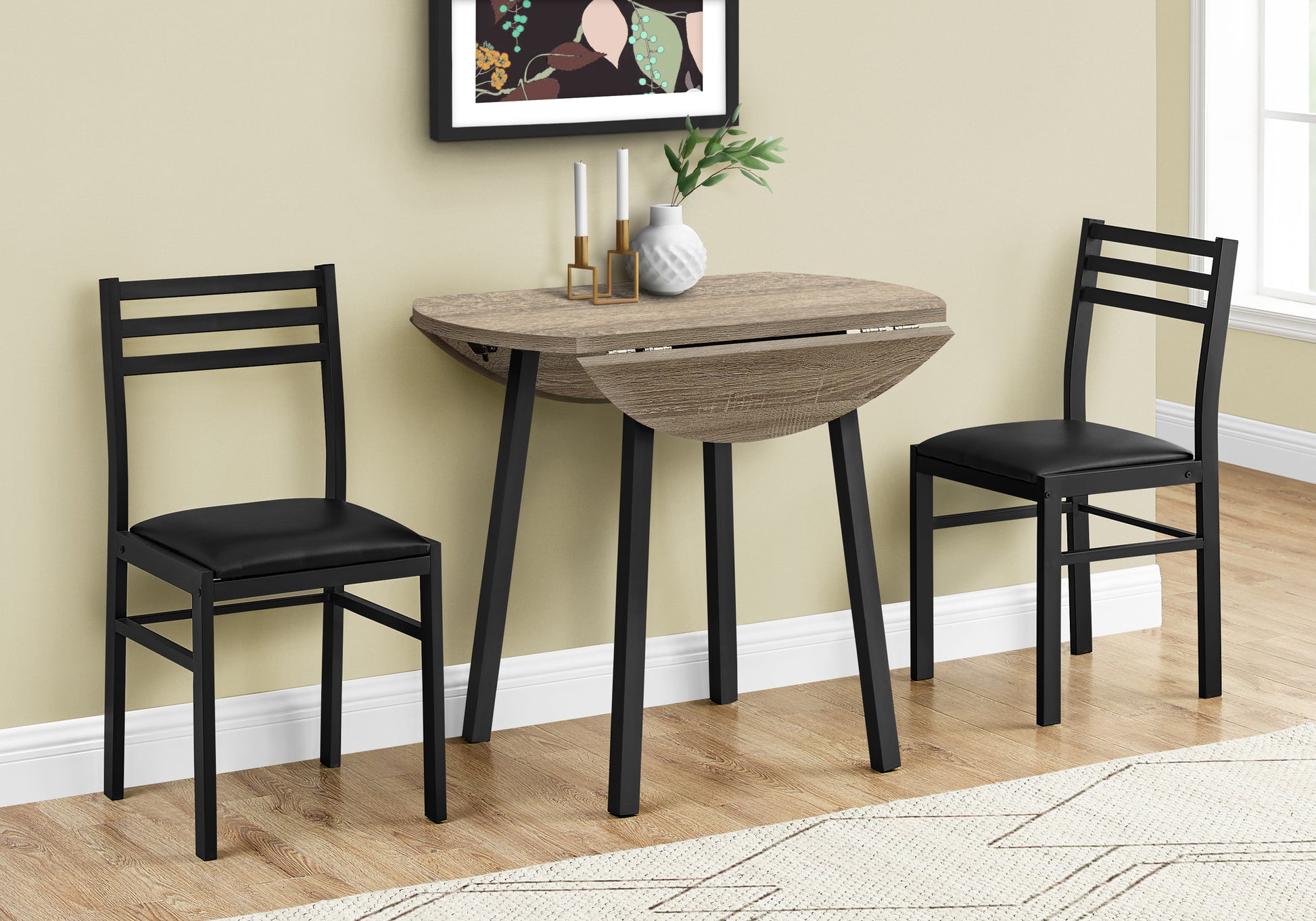 Compact drop leaf dining table with two black chairs