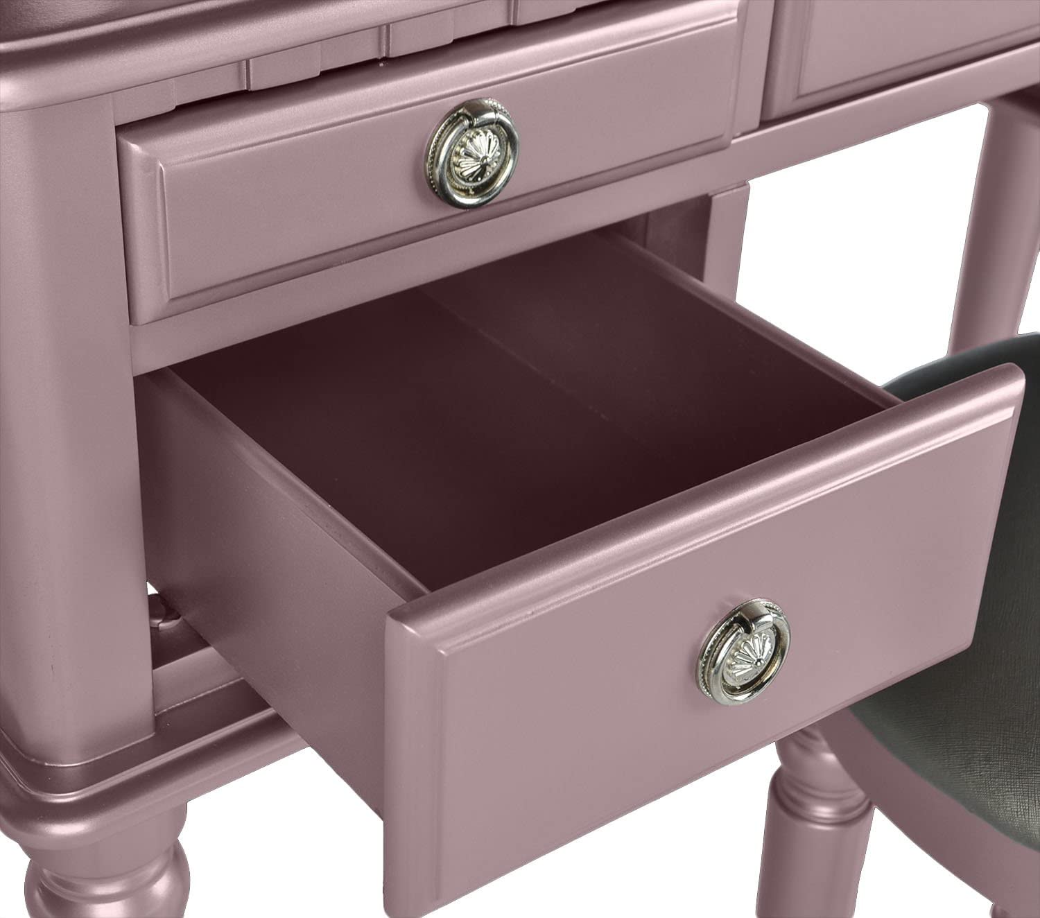 Rose gold vanity with ornate drawer pulls and open drawer