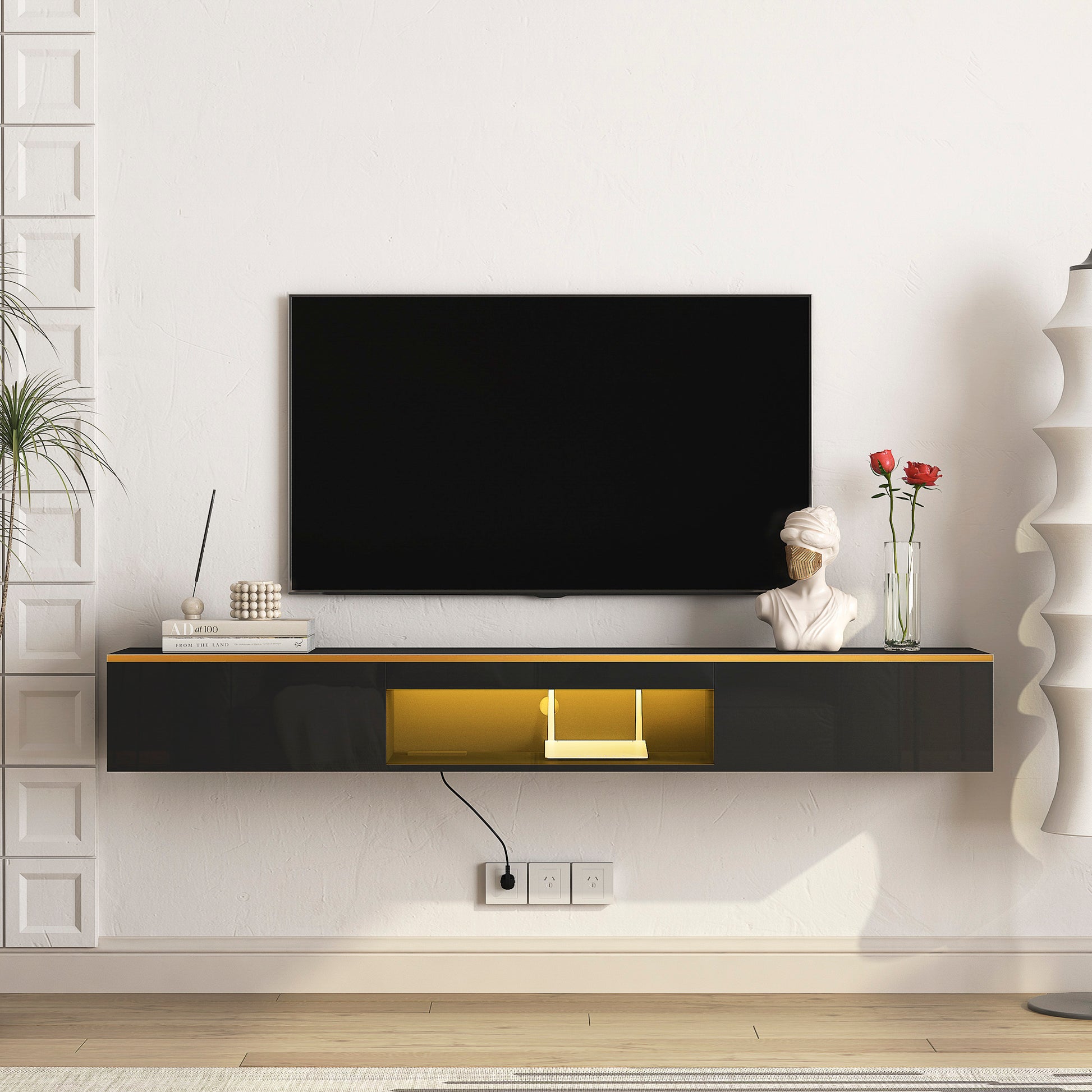 Sleek black floating TV stand with a golden trim and illuminated open shelf for media consoles