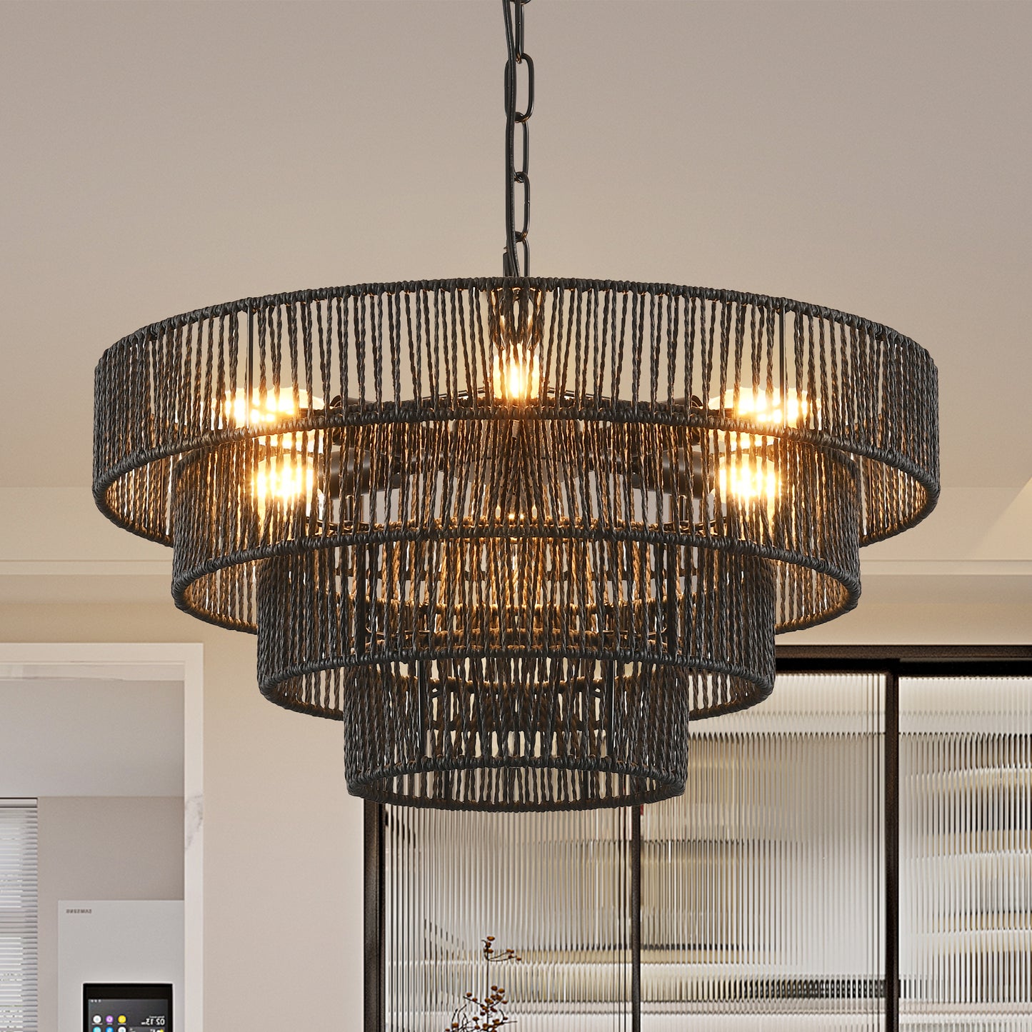 Multitiered black rope chandelier with exposed bulbs illuminates dining spaces