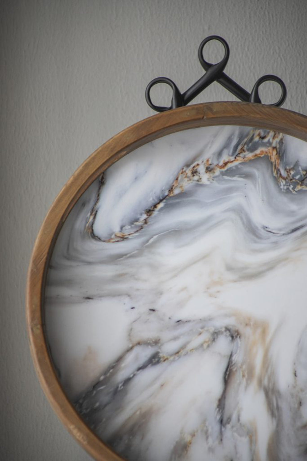 Round wooden tray with realistic white marble resin top and black handles