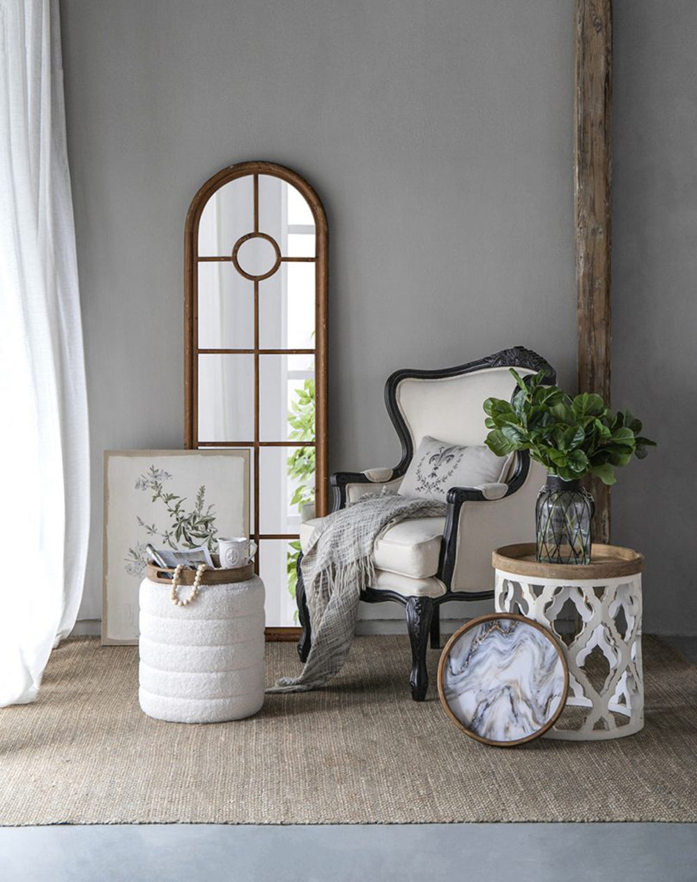 Tall arched wooden mirror with subtle distressed finish and central circular pane