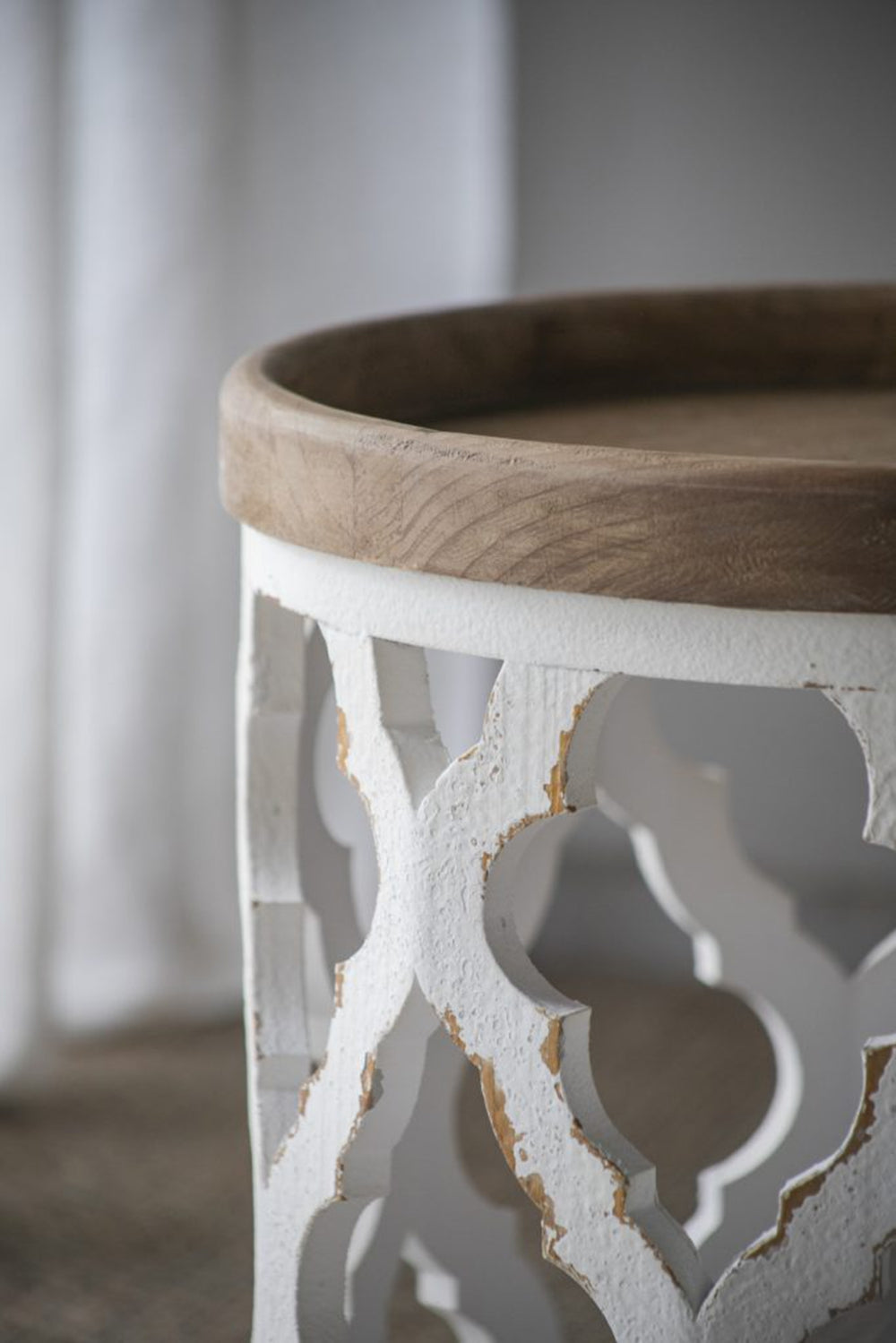 White carved wooden side table with distressed finish and natural wood top