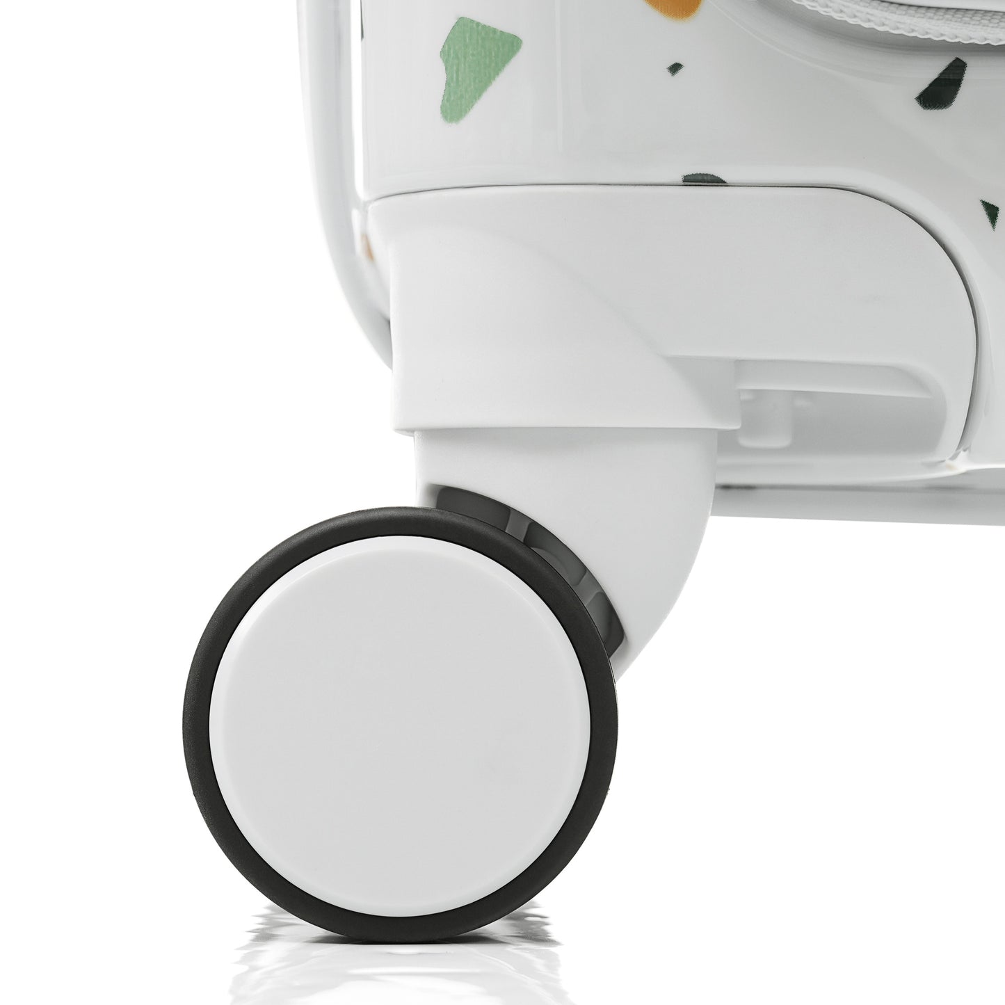 Closeup of a white luggage wheel with black trim on a patterned suitcase