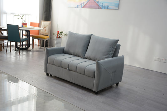 Gray velvet sofa bed with tufted seat cushions and plush throw pillows