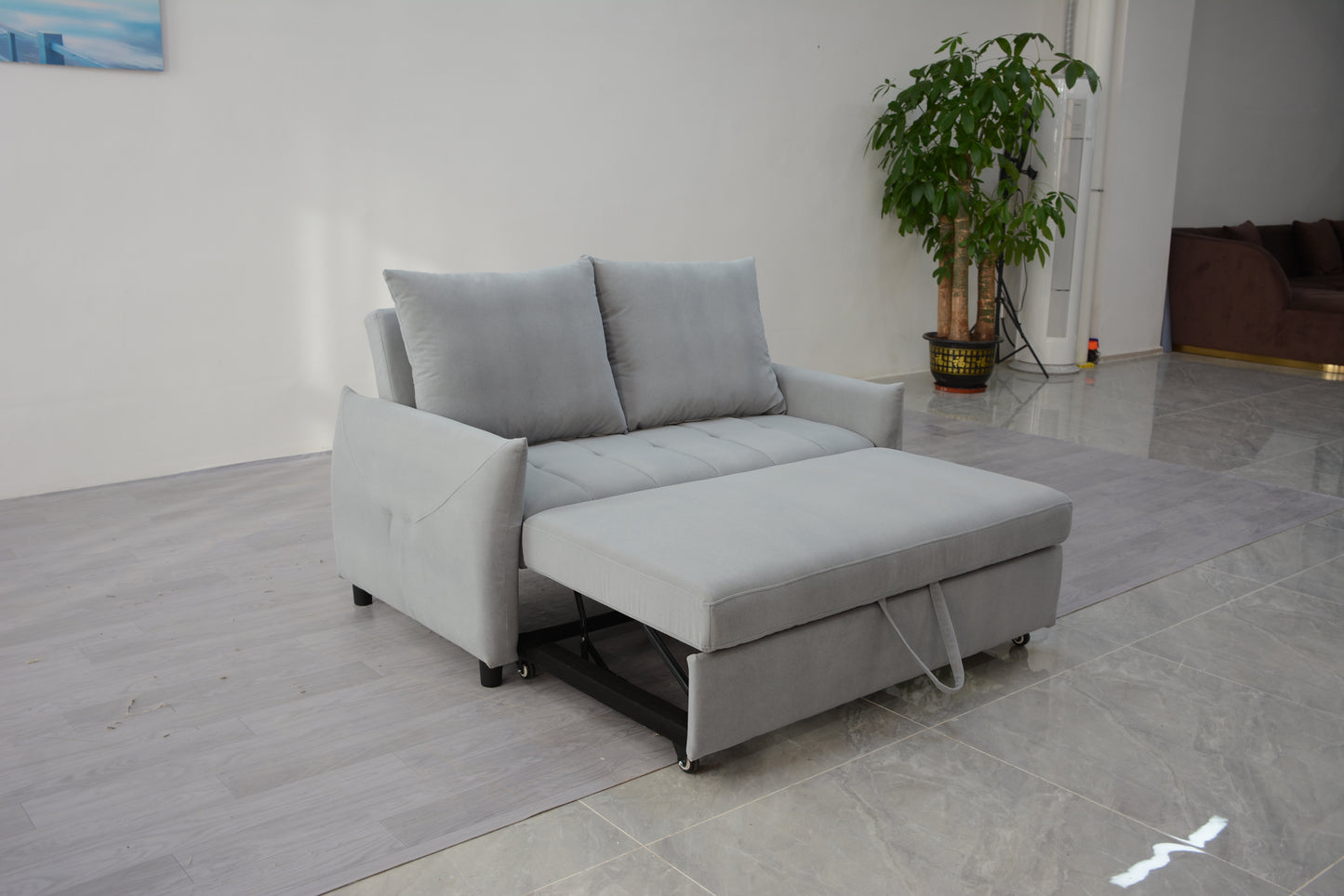 Light gray velvet sofa bed with pullout ottoman for compact living spaces