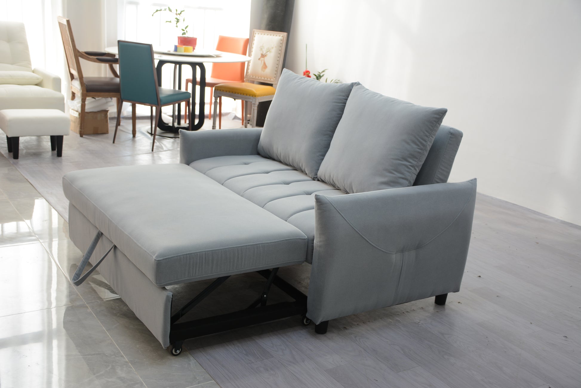 Gray fabric sofa bed with chaise convertible to a guest bed for small spaces