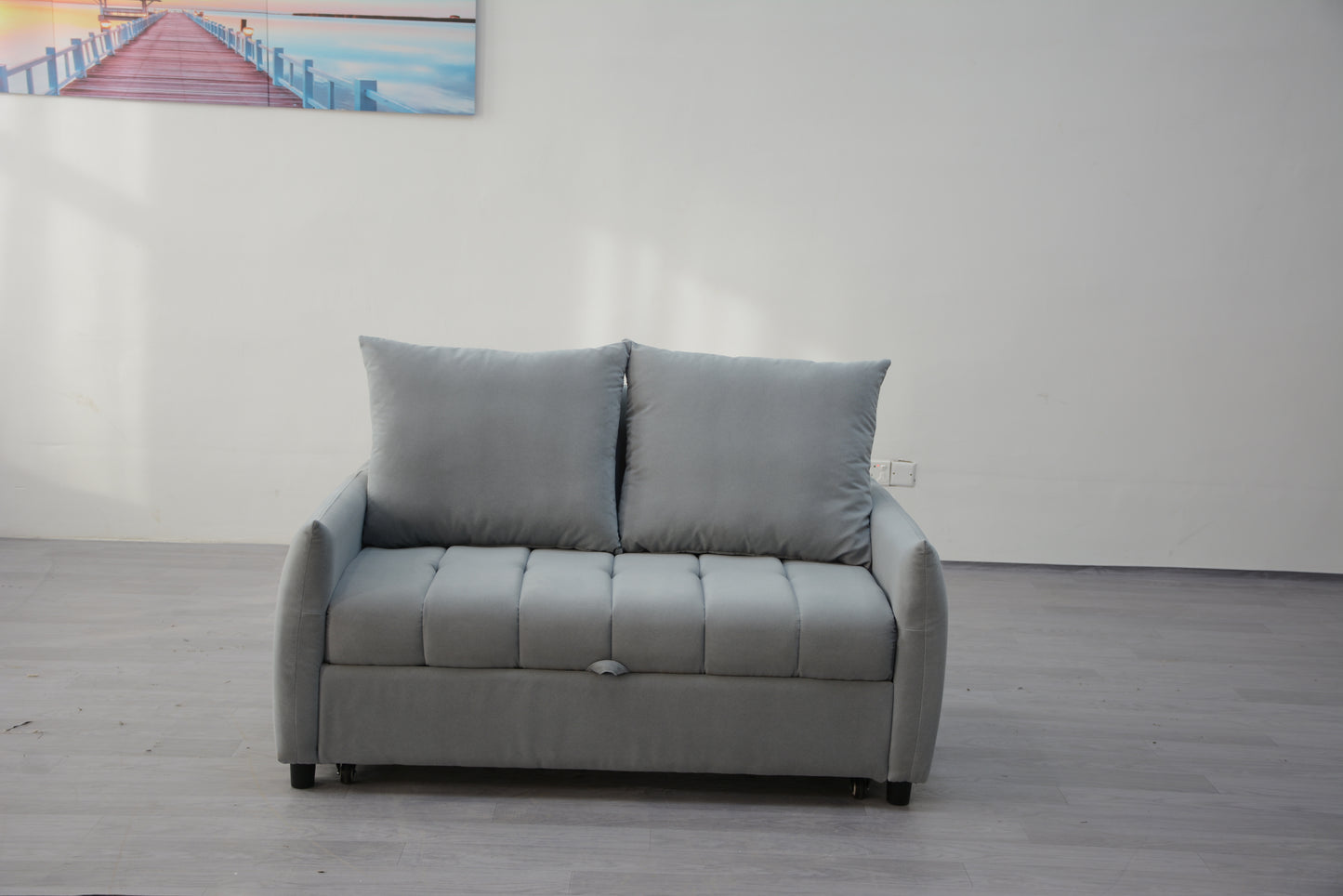 Gray upholstered loveseat sofa with tufted seat and plush cushions perfect for small living spaces