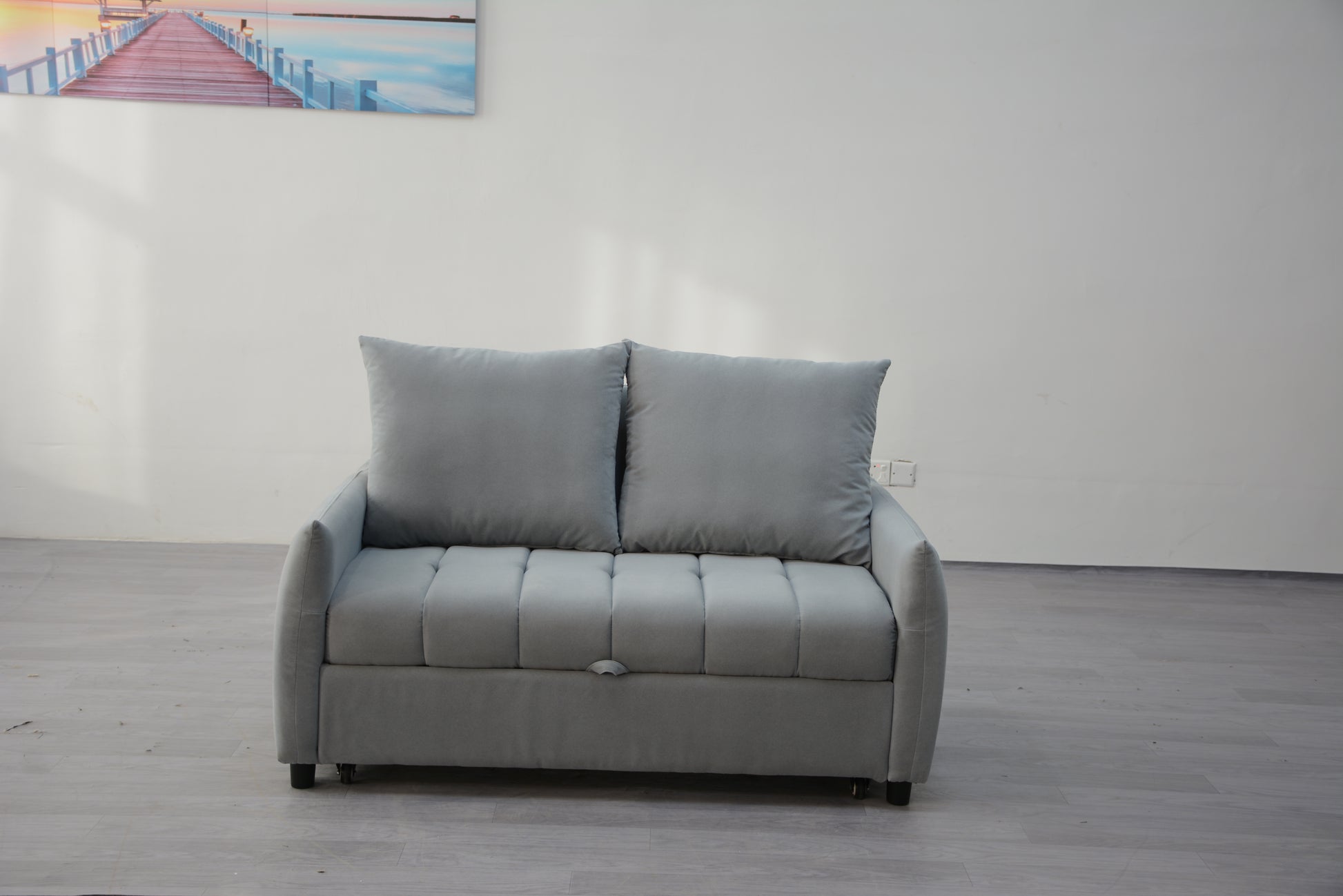 Gray upholstered loveseat sofa with tufted seat and plush cushions perfect for small living spaces