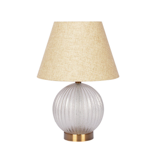 Textured glass table lamp with beige linen shade and brass base