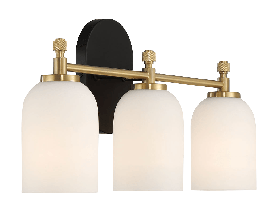 Three white frosted glass globe vanity lights with brass accents and a black backplate