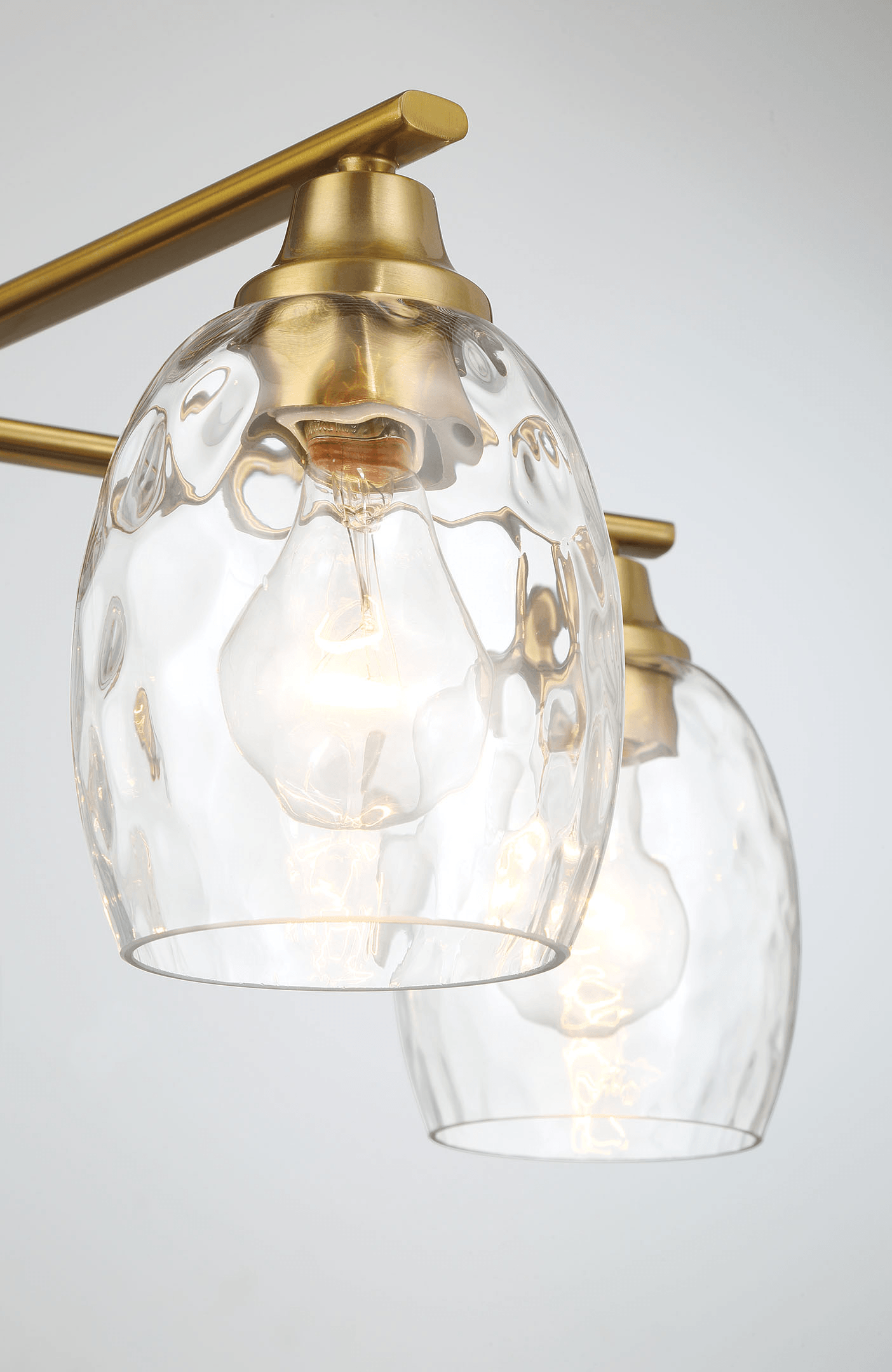 Brass finish chandelier with clear textured glass shades and Edison bulbs