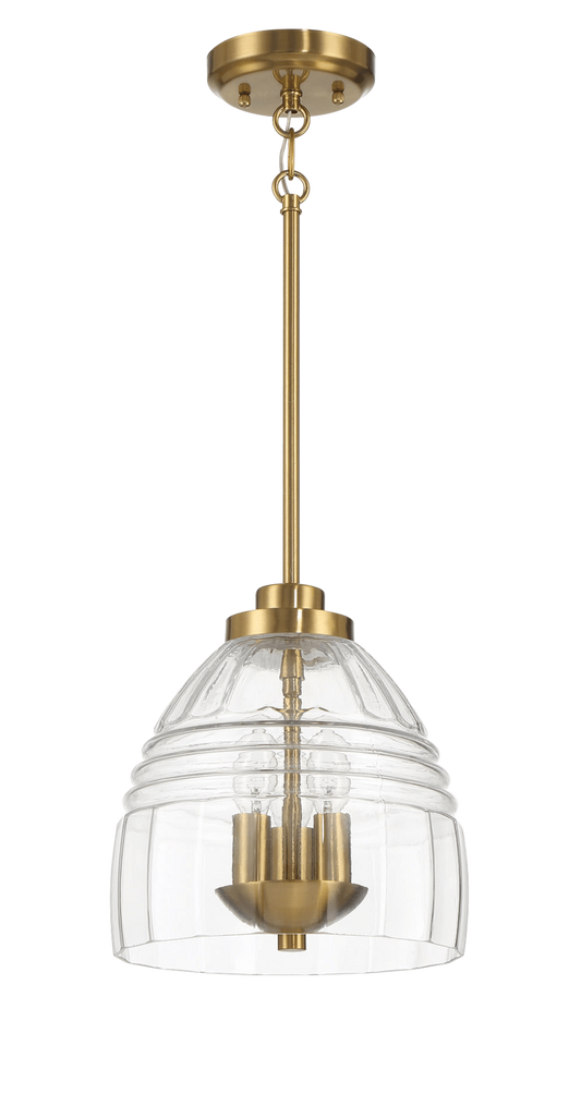 A modern brass pendant light with a clear ribbed glass shade and three exposed bulbs