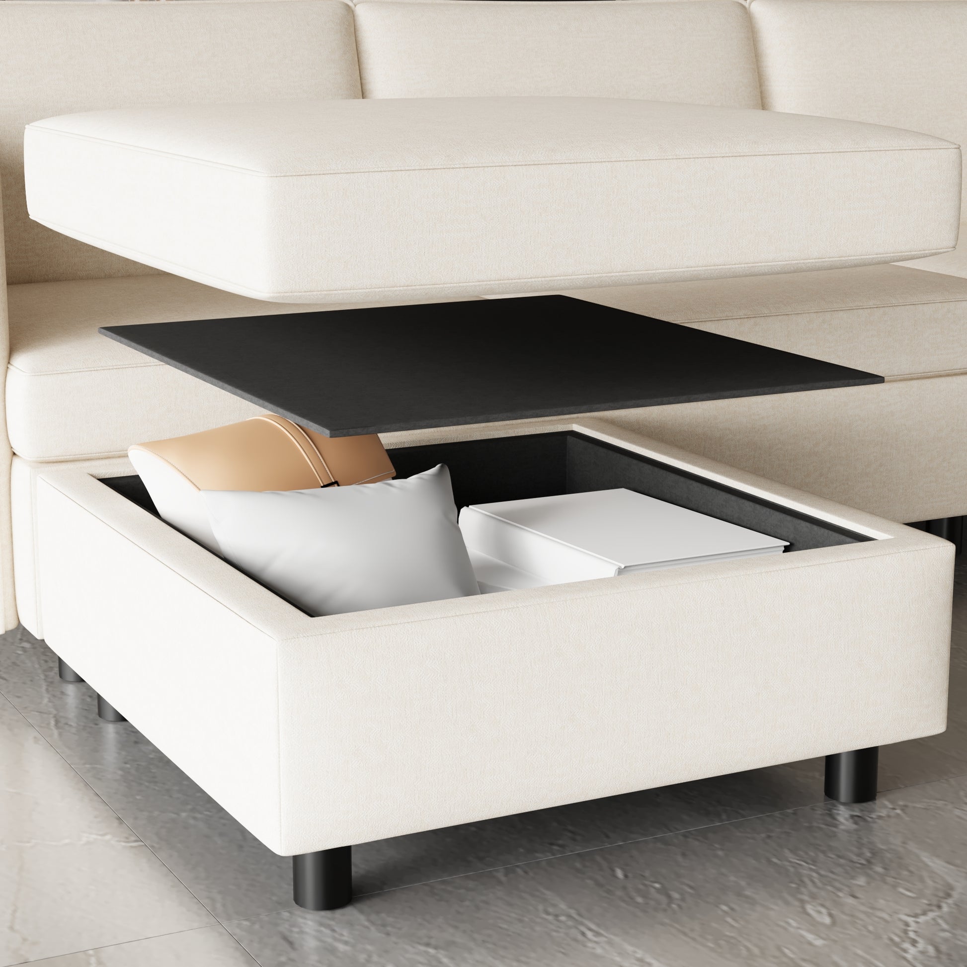 Cream fabric storage ottoman with black tray and pillows offering hidden compartment space