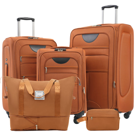 Set of four orange fabric luggage pieces including suitcases and duffel bag