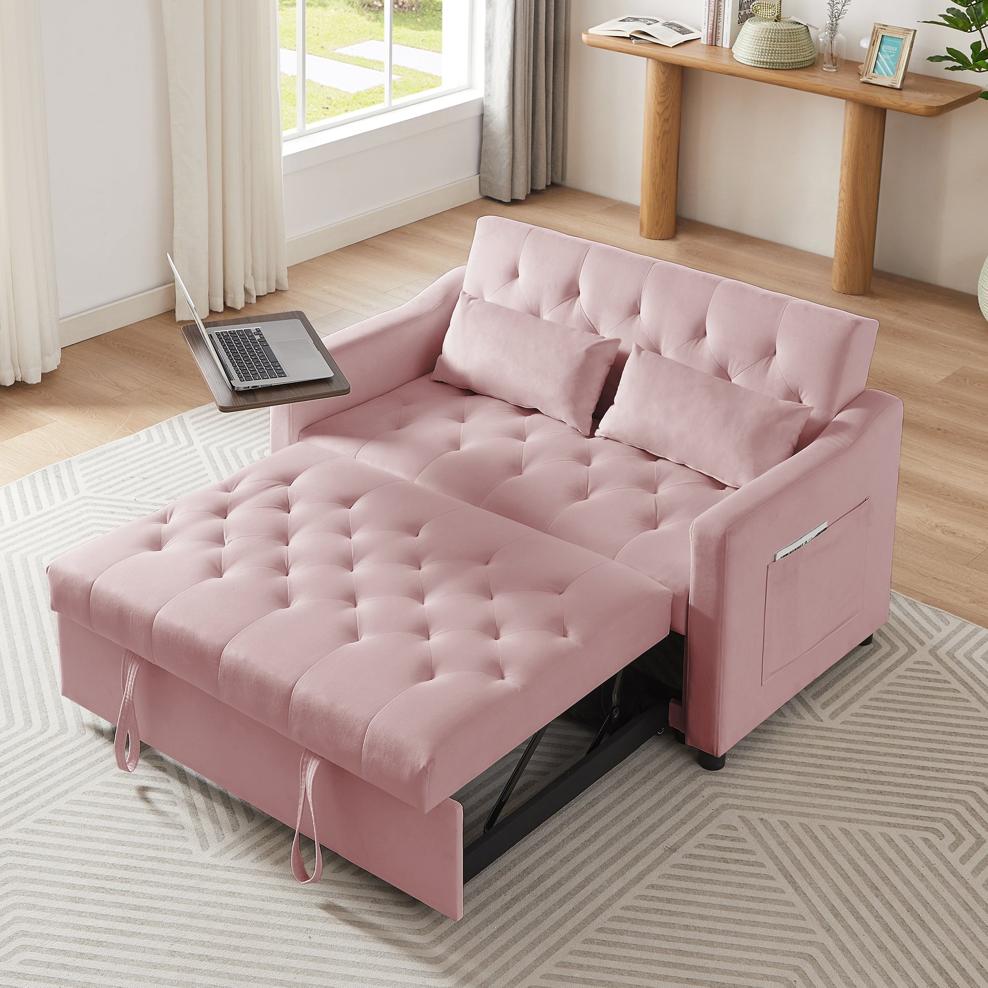 Pink velvet tufted sofa bed with pullout ottoman for versatile living space