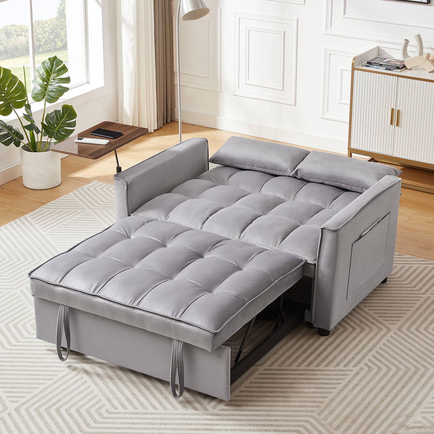 Gray velvet sofa bed partially pulled out showing tufted cushions and storage pocket