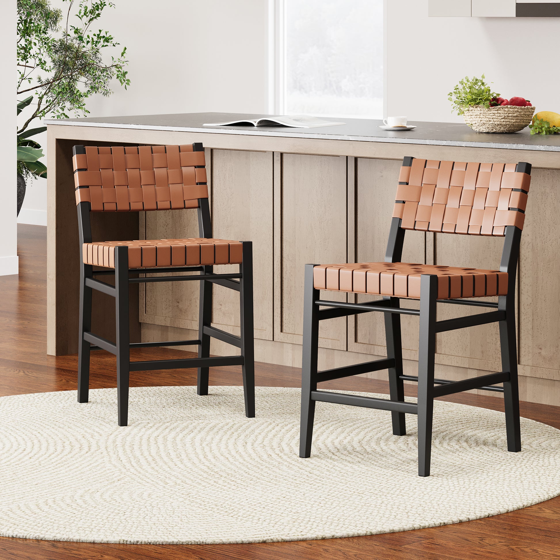 Two modern tan leather woven bar stools with black metal frames on a round rug
