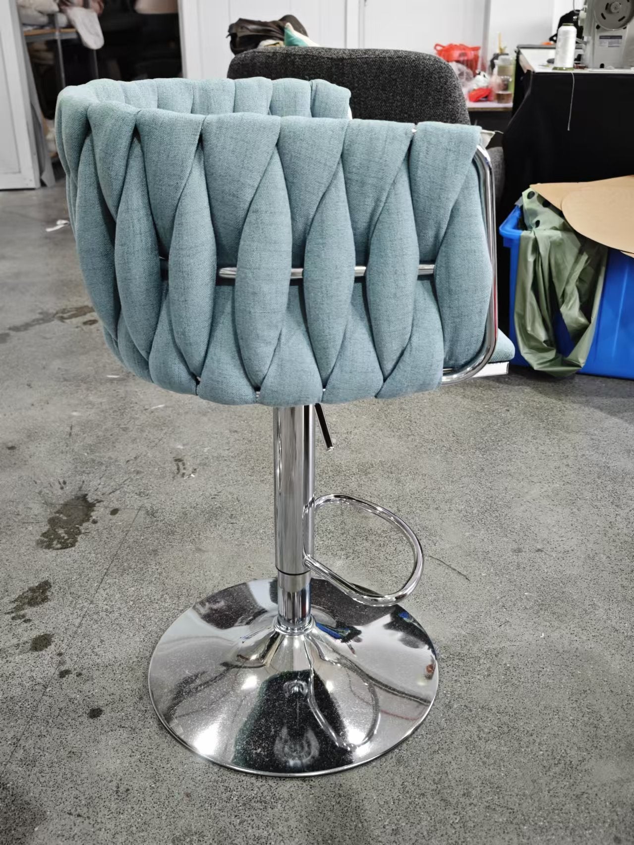 Teal upholstered bar stool with braided backrest and chrome base