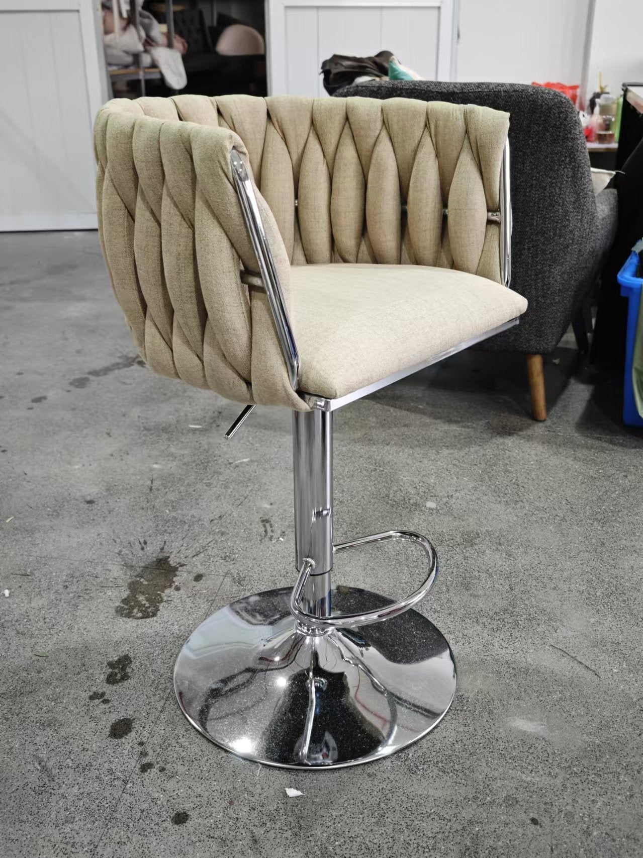 Tufted beige fabric bar stool with chrome base and adjustable height