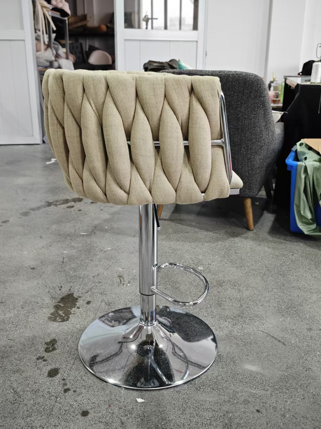 Beige textured fabric bar stool with chrome base and footrest