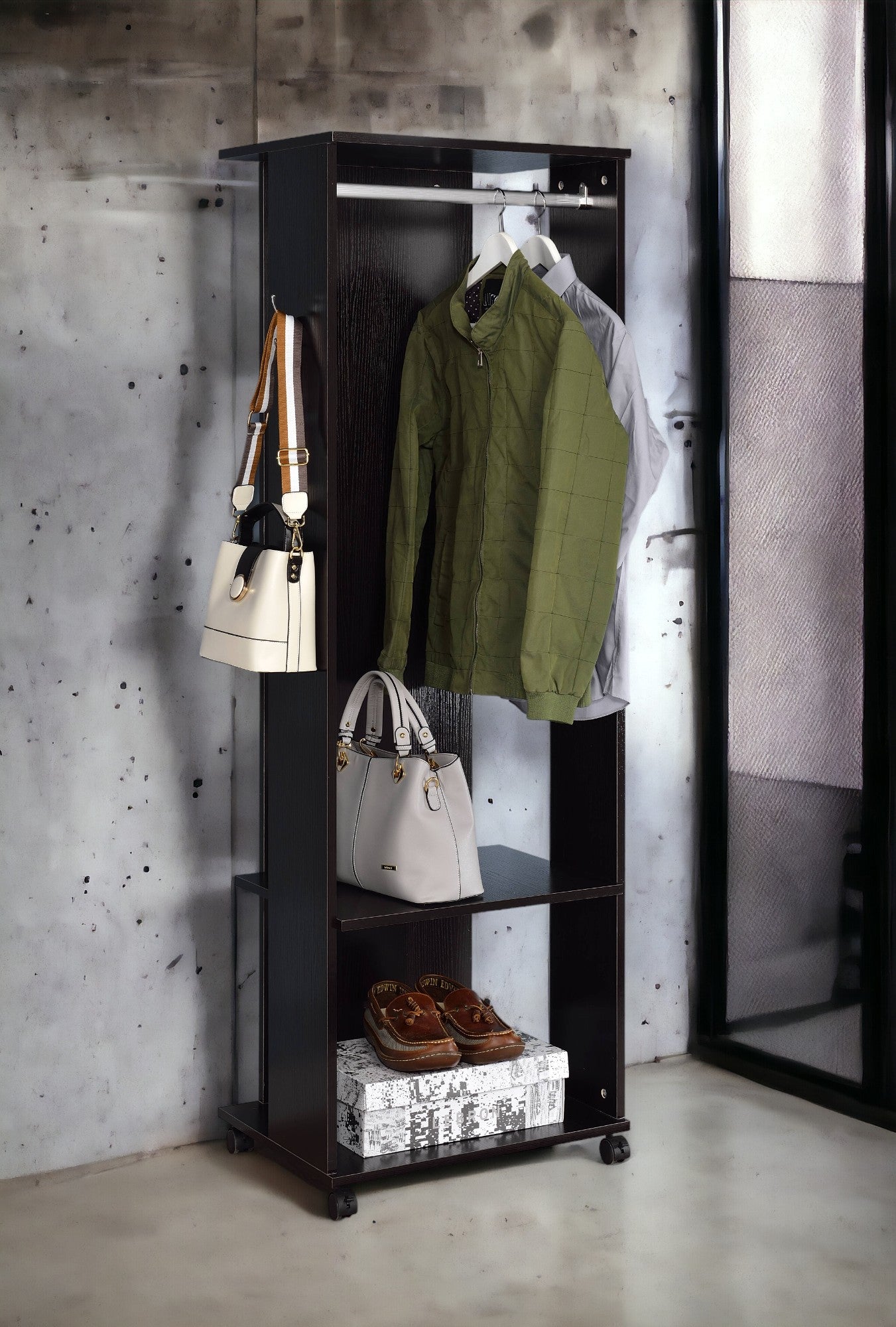Dark wood garment rack with green jacket and white handbag
