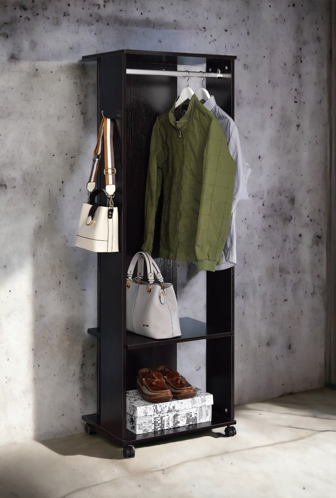 Dark wood garment rack with hanging jackets and handbags