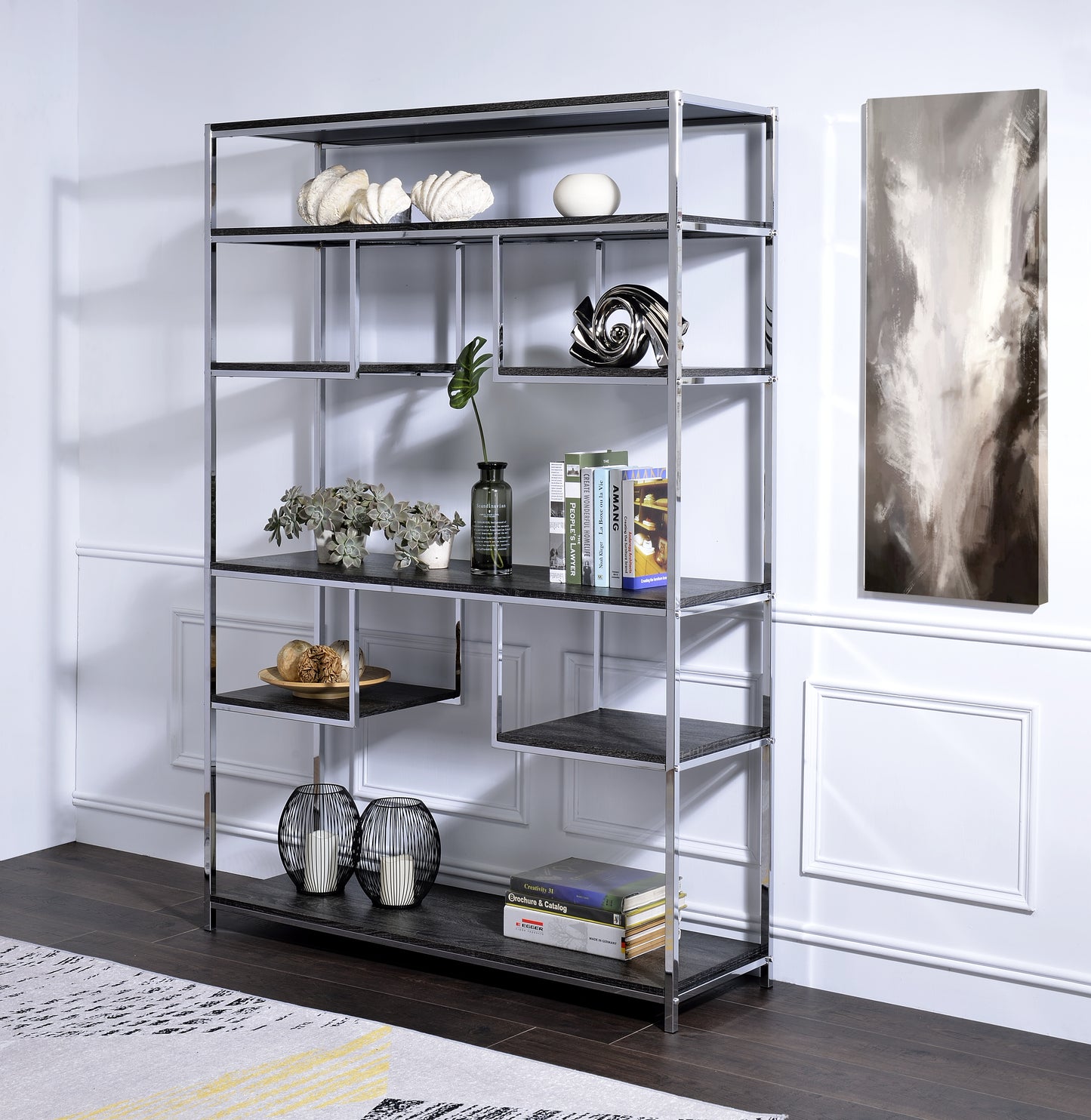 Modern chrome and black bookshelf with staggered shelves displaying decor