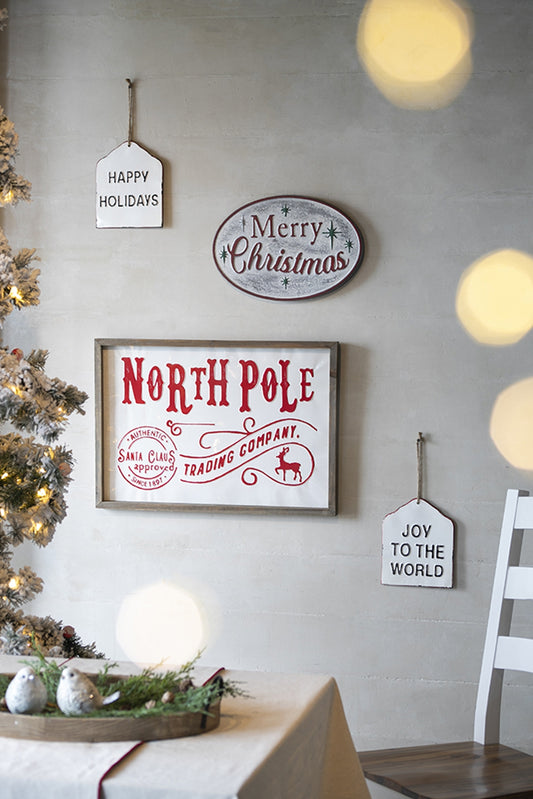 Farmhouse style white metal sign with Happy Holidays text hung by twine