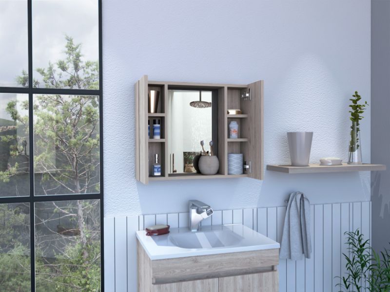 Light oak medicine cabinet with mirrored door organizing bathroom essentials